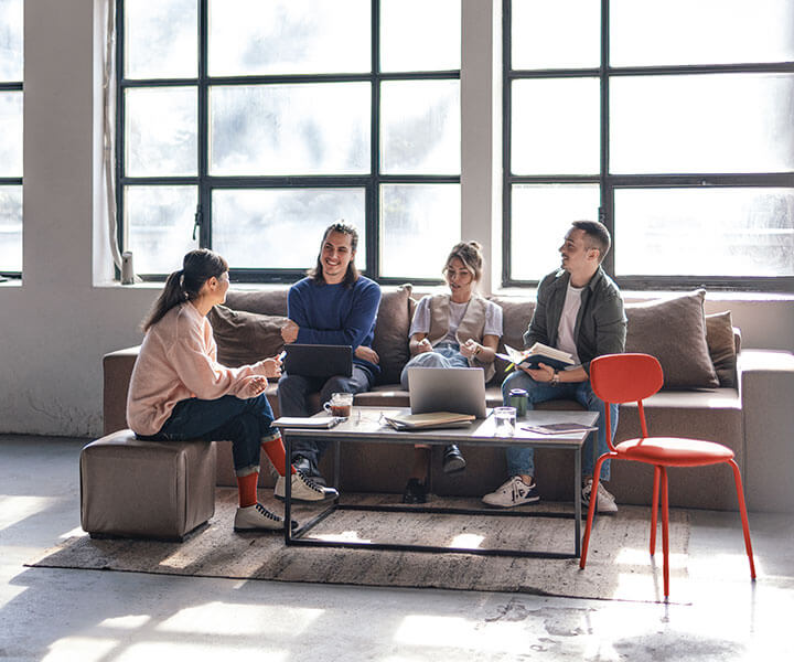 Group of young colleagues collaborating in a loft space